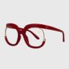 A pair of stylish glasses featuring a red frame with elegant gold detailing.