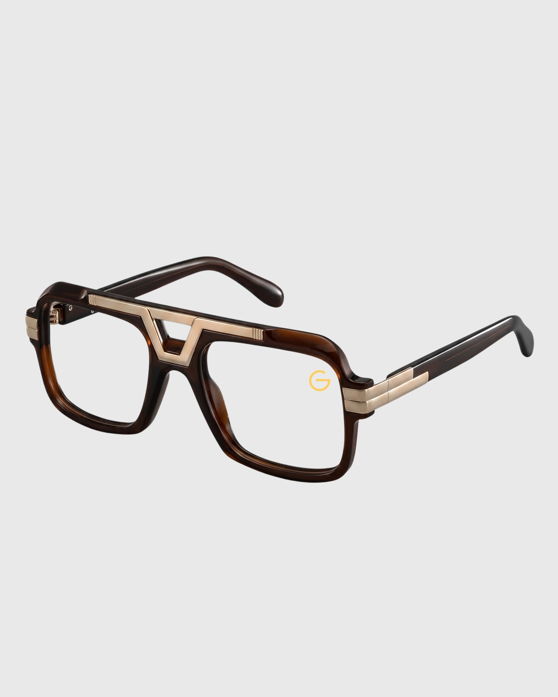 A pair of glasses featuring a gold frame and brown temples, elegantly designed for stylish eyewear.