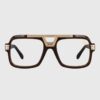 A pair of stylish glasses featuring brown and gold frames, showcasing a modern design.