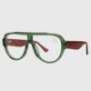 A pair of glasses featuring green frames and red temples, showcasing a vibrant and stylish design.
