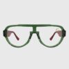A pair of glasses featuring green frames and red temples, showcasing a vibrant and stylish design.