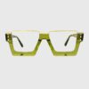 A pair of glasses featuring green frames with elegant gold rims.