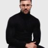 A man wearing glasses and a black turtleneck sweater, looking thoughtfully to the side.