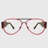 A pair of glasses featuring a stylish design with red and black frames.