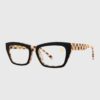 A pair of glasses featuring checkered frames, showcasing a stylish and unique design.
