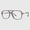Glasses featuring gold rims and clear lenses, elegantly designed for a sophisticated look.