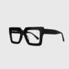 A pair of black-framed glasses resting on a flat surface.