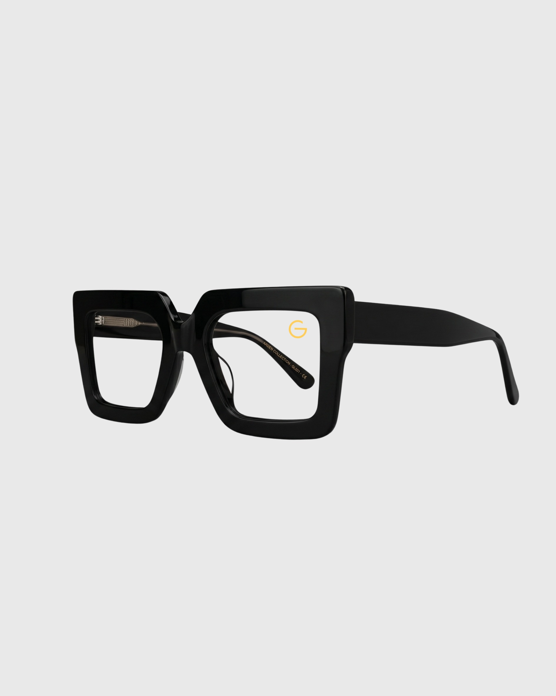 A pair of black-framed glasses resting on a flat surface.