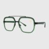 A pair of glasses featuring a green frame and black temples, showcasing a modern and stylish design.