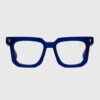 A pair of glasses featuring a blue frame and a gold logo on the temple.