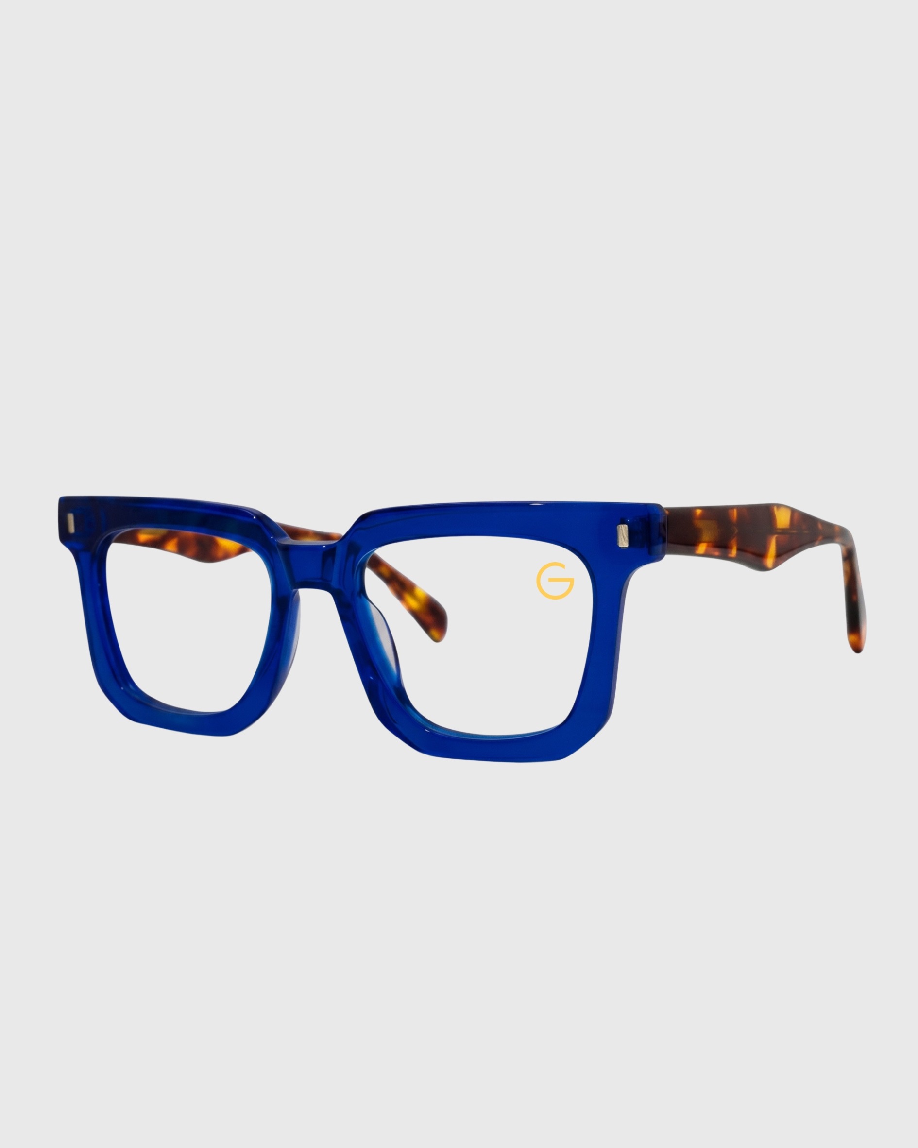 A pair of eyeglasses featuring blue frames and tortoise shell accents, displayed against a neutral background.