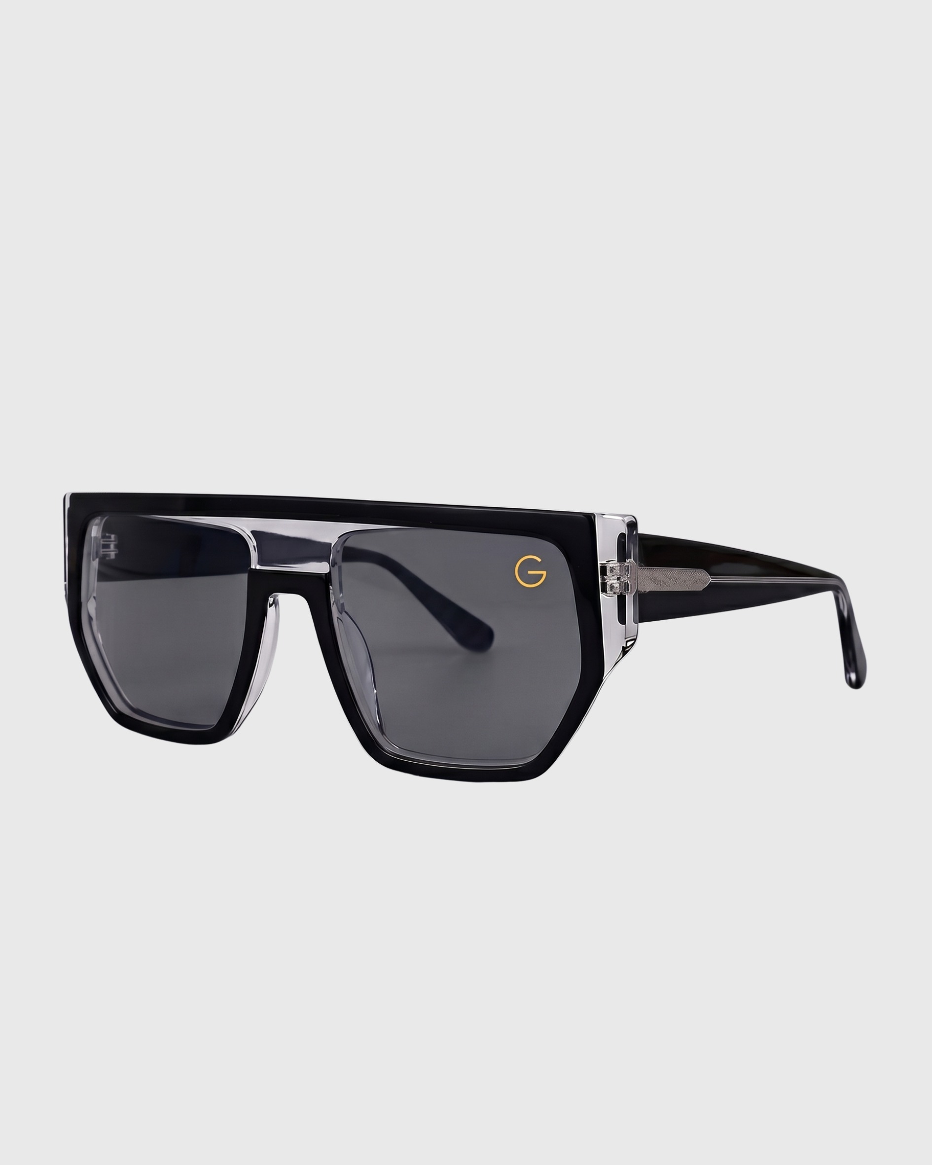 Black sunglasses featuring a gold logo on the side, showcasing a stylish and modern design.