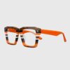 A pair of glasses featuring orange and brown stripes on the frames, showcasing a stylish design.