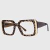 Leopard print glasses with gold accents, showcasing a stylish and bold design.