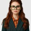 A professional woman in a suit and glasses, exuding confidence and sophistication.