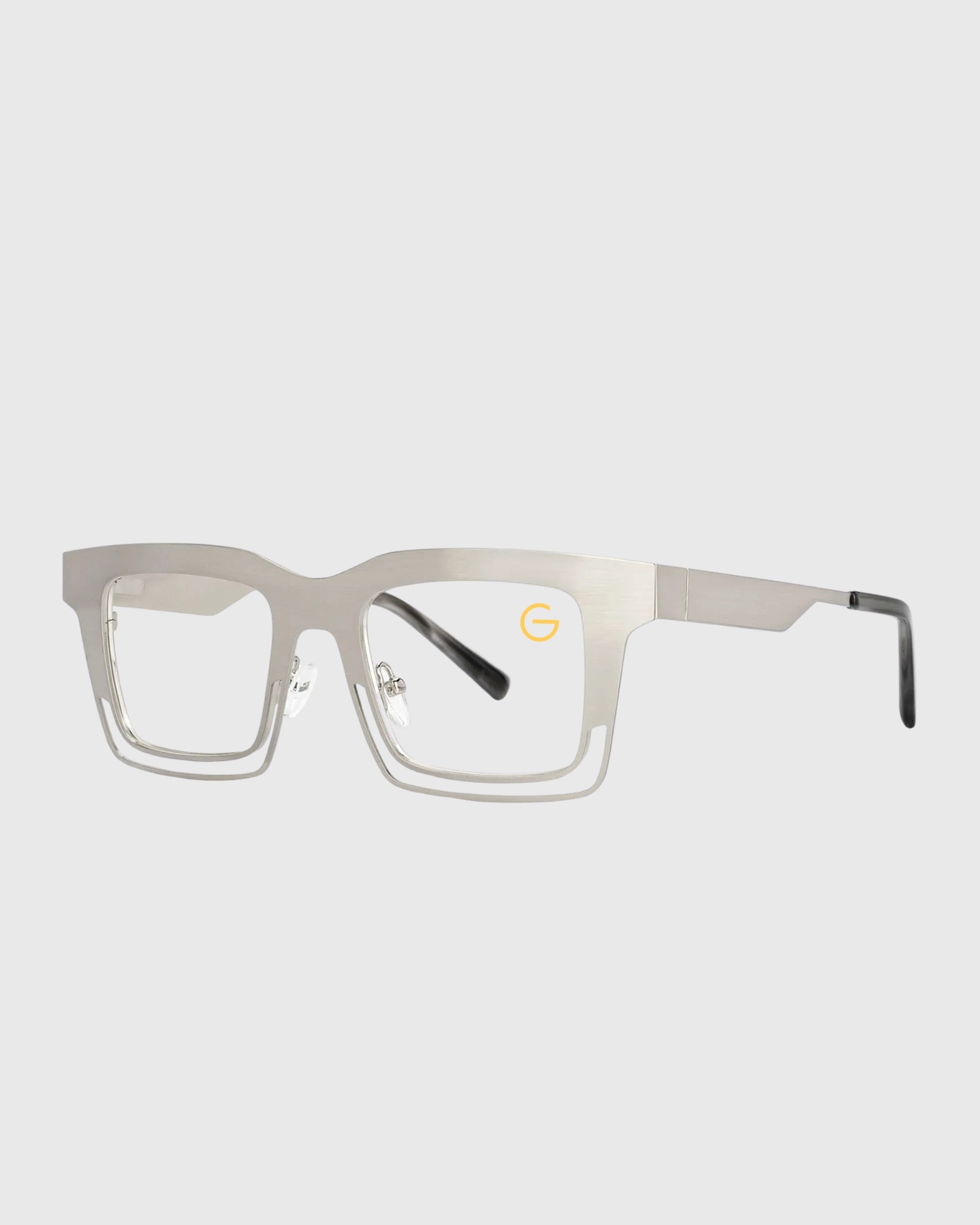 A pair of silver-framed glasses with clear lenses displayed on a neutral background.