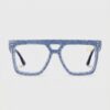Blue denim glasses with a sleek metal frame, showcasing a unique and stylish design.