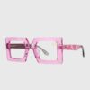 A pair of square-shaped glasses featuring pink frames, showcasing a stylish and modern design.