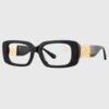A pair of black and gold glasses featuring a stylish gold chain attached.