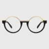 A pair of eyeglasses featuring gold frames and black temples, elegantly designed for a stylish look.